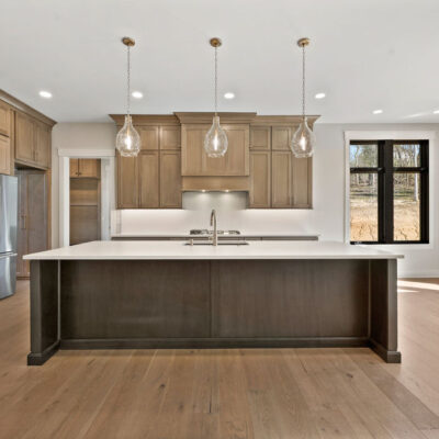 Custom Kitchen With Stained Cabinetry, Quartz Countertops and Hidden Pantry