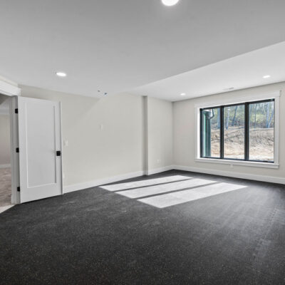 Lower Level Exercise Room With Custom Wood Shelf and Black Trim Window