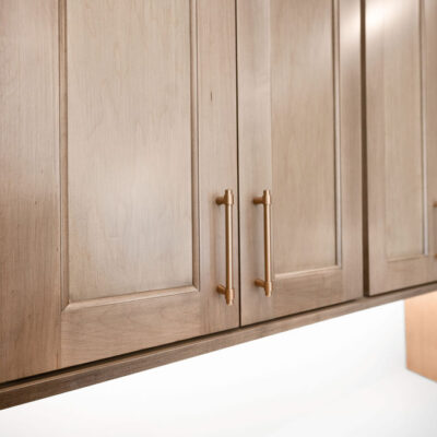 Stained Wood Cabinetry With Gold Accent Hardware