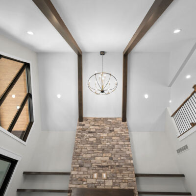 Great Room With Stone Fireplace and Access To Covered Screened-In Porch