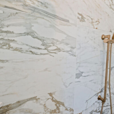 Primary Bathroom Shower With Alustra Imperial Gold Matte Tile 24x48 Gold Plumbing Hardware