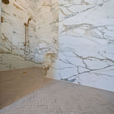 Primary Bathroom Shower With Alustra Imperial Gold Matte Tile 24x48 Gold Plumbing Hardware Herringbone time zero entry shower