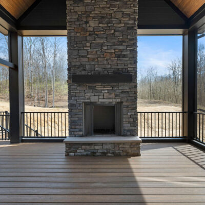 Screened Porch with Cathedral Ceiling and Stone Fireplace at Bear Creek Pella Sliding Doors and Custom Grilling Station