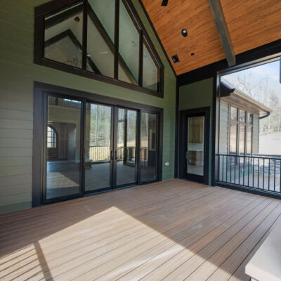 Screened Porch with Cathedral Ceiling and Stone Fireplace at Bear Creek Pella Sliding Doors and Custom Grilling Station