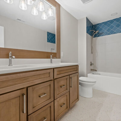 Second Floor Hall Bathroom Custom Framed Mirror matching custom wood stained cabinetry