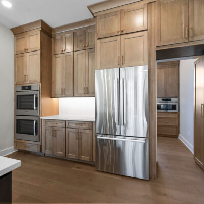 Appliance Wall and Hidden Pantry In Custom Home Kitchen