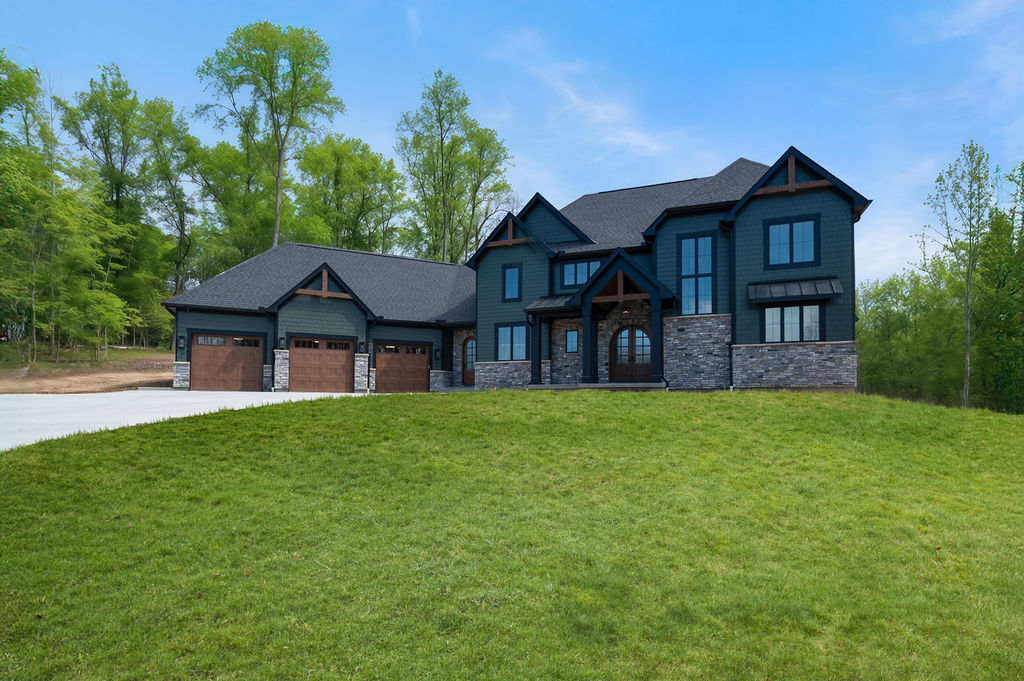 Two Story Custom Home Cleaves Stone Dark Green Siding Stone and Cedar Accents