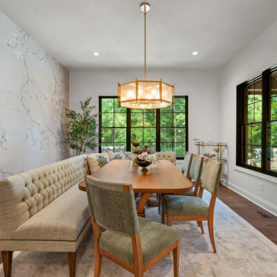 Dining area with soft floral wallpaper and black framed windows