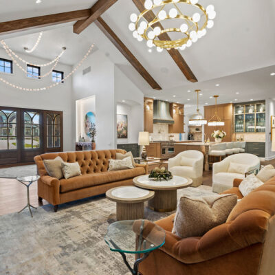 Vaulted Ceiling With Beams and Stone Fireplace In Great Room With Entry and Kitchen