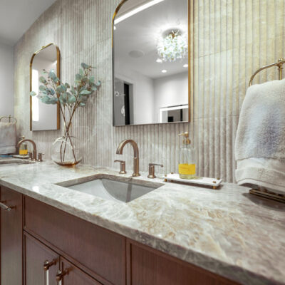 Fluted Travertine Backsplash With Taj Mahal Quartzite in Primary Bathroom
