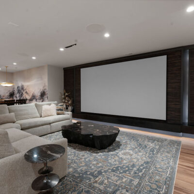 Media Room with Textured Wallpaper and 2 Sided Fireplace