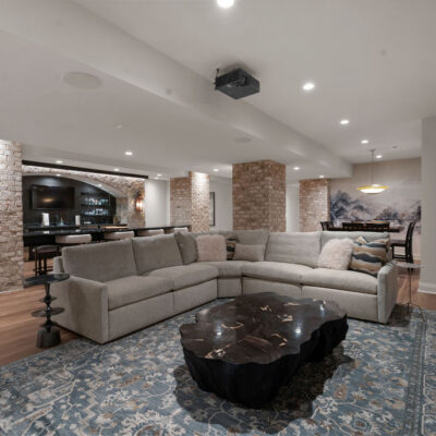 Media Room with Double Sided Island Seating and Large Stone Bar