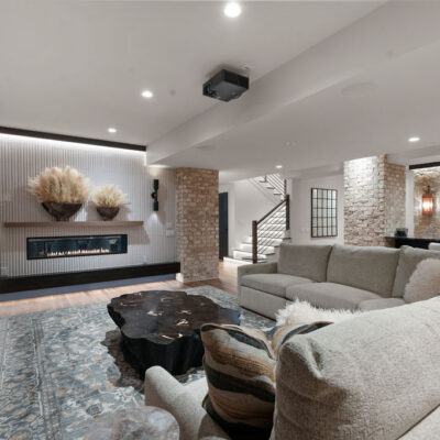 Media Room With Two Sided Fireplace With Fluted Travertine Tile