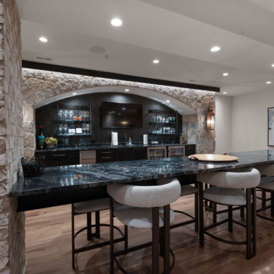 Double Sided Island Seating and Large Arched Stone Bar