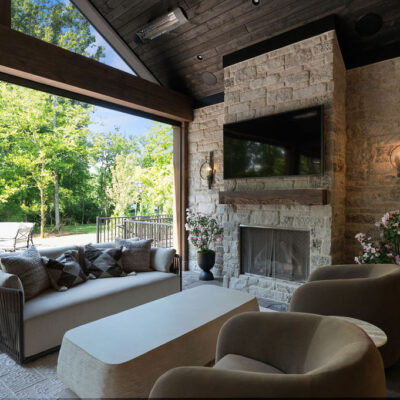 Covered Porch With Stone Fireplace and Seating Area Vaulted Ceiling