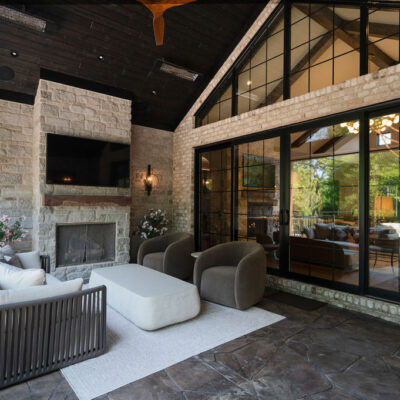 Covered Porch With Stone Fireplace and Seating Area Vaulted Ceiling