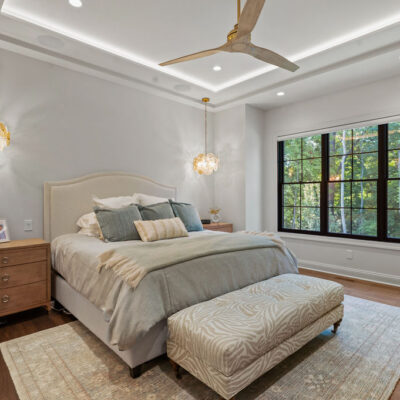 Primary Bedroom Tray Ceiling With Lighting and Black Framed Windows