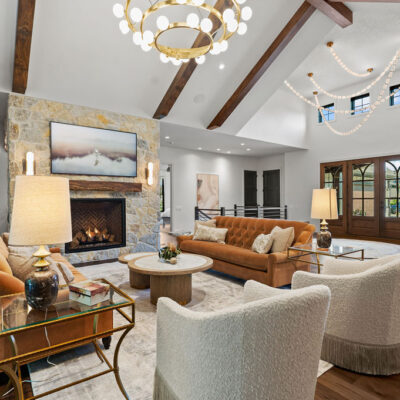 Statement Chandelier Coordinates With Alabaster Glass Sconces in Great Room