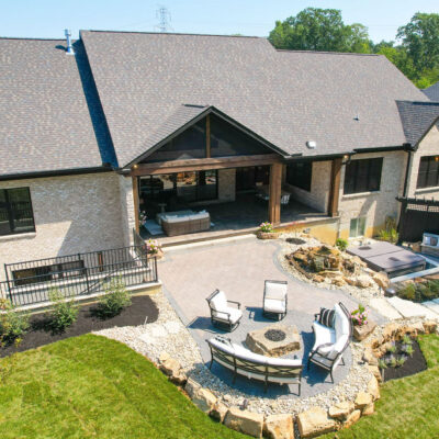 Rear Exterior with Covered Porch Firepit Area Stone Stairs to Hot Tub and Curved Stone Bench