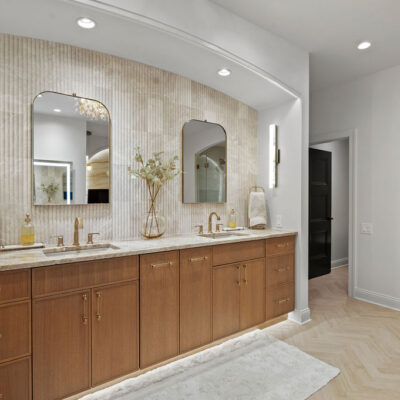 Primary Bathroom Double Vanity With White Oak Rift-Cut Cabinetry Travertine Backsplash