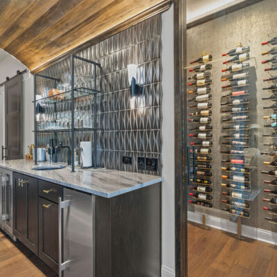 First Floor Wet Bar With Barrel Wood Ceiling and Wine Cellar With Glass Door