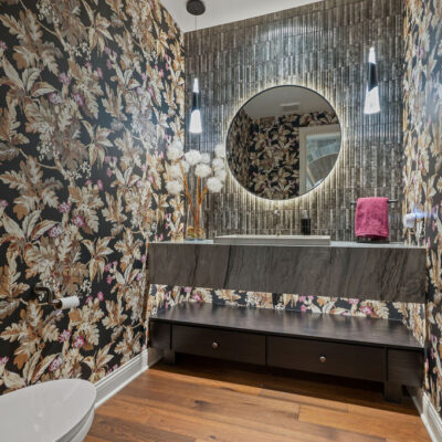 Powder Room With Floating Vanity and Cement Sink With Pendant Lighting and Backlit Mirror