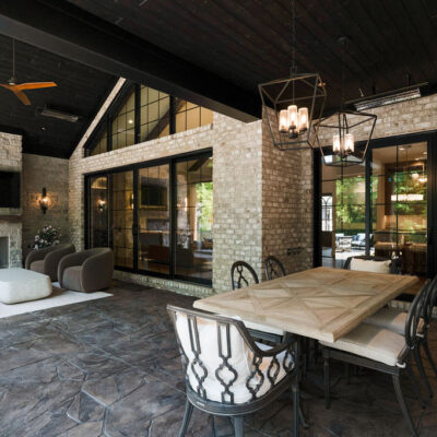 Covered Back Porch With Fireplace Seating Area and Dining Area