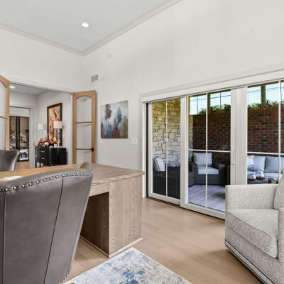 Home Office With Custom Wood Stained Built-Ins His and Her Peninsula Desk and Access To Screened In Porch