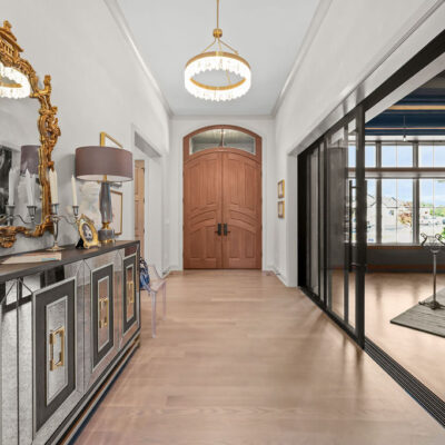 Entryway With Mahogany Door With Transom and Piano Room With Sliding Glass Doors