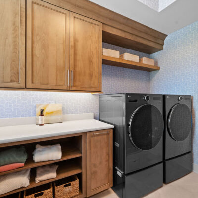 Laundry With Window and Closed and Open Custom Cabinetry, Sink and Washer and Dryer on Pedestal