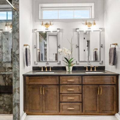 Guest Bathroom Double Vanity With Stained Wood Custom Cabinetry and Transom Window Above Vanity