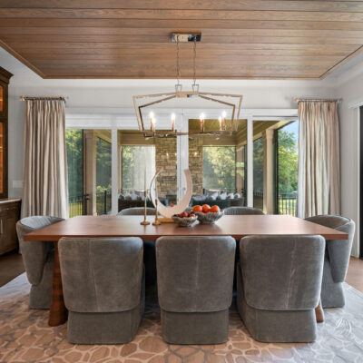Dining Area Off Kitchen With Dropped Ceiling With Accent Lighting and Tongue and Groove Wood With Dark Built-In Cabinetry and Herringbone Tile Backsplash Access To Screened In Porch and Sun Deck