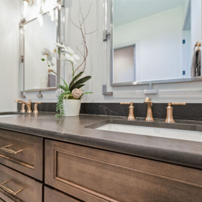 Guest Bathroom Double Vanity With Stained Wood Custom Cabinetry and Transom Window Above Vanity