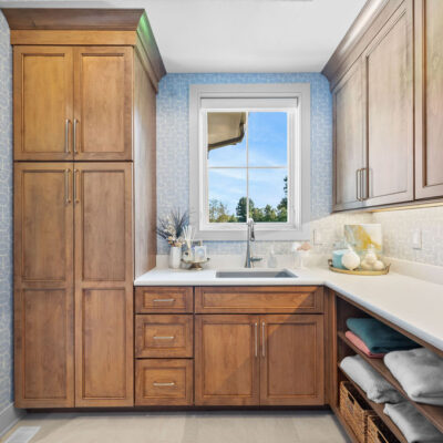 Laundry With Window and Closed and Open Custom Cabinetry and Sink