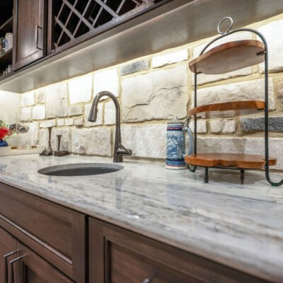 Lower Level Wet Bar With Stone Backsplash and Kegerator