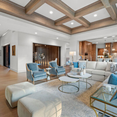 Great Room Off Entry and Kitchen With Linear Fireplace Dark Stained Built-Ins With Wood Coffered Beam Ceiling Sliding Door With Transom Above