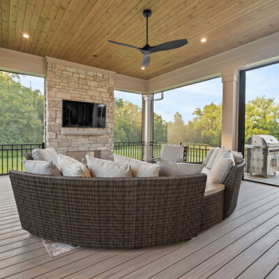 Covered Screened In Porch With Stone Fireplace