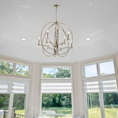 Octagon Shaped Primary Bedroom With Large Windows With Transom Above