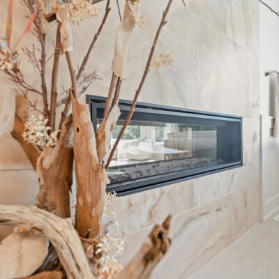 Two Sided Fireplace Between Primary Bedroom and Bathroom